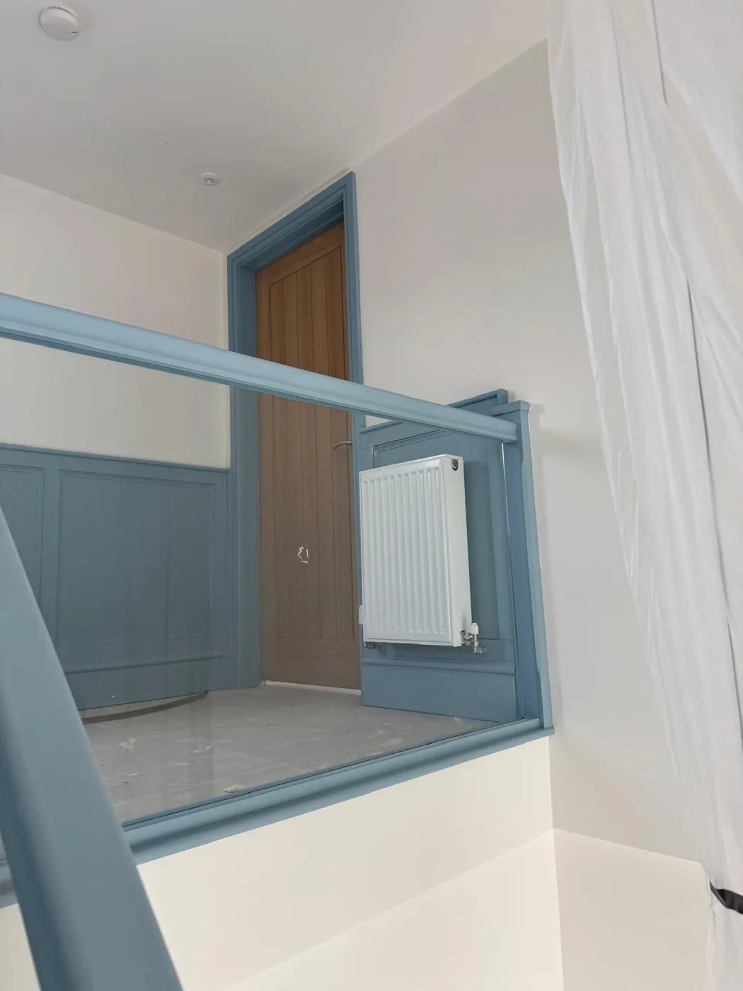 School landing with hand-painted blue wainscot panelling